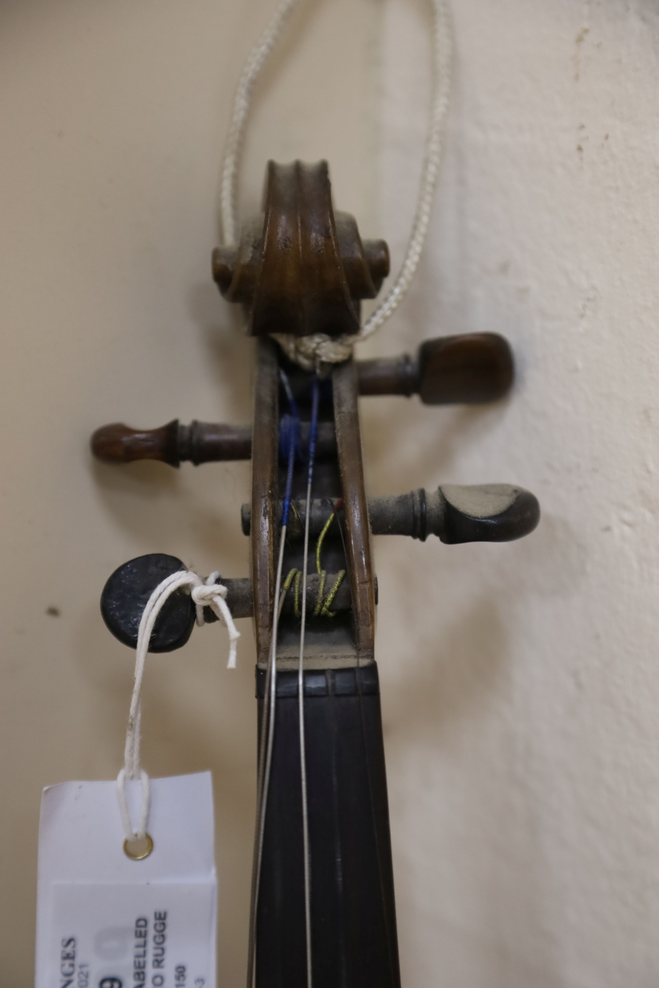 A violin labelled Francesco Ruggeri and a bow. Back of violin excluding button - 36cm